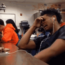 ericthnkr-guy-crying-while-listening-to-music